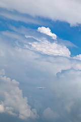 A Cessna aircraft flying in the storm cloud and blue sky on above