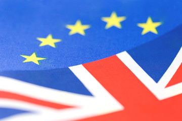 Background of EU and UK waving flags, part of Union Jack visible with copy space. Brexit and cooperation concept