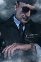Vintage world war 2 pilot looking at watch.