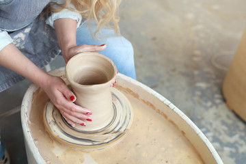 girl makes a jug of his own hands in a pottery workshop