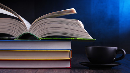 Composition with books and cup of coffee on the table