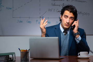 Financial specialist working late in the office