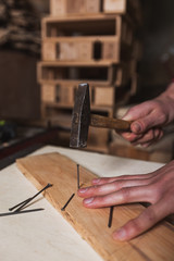 Close up hammering a nail 