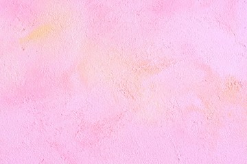 Pink decorative plaster texture background with yellow and beige abstract spots and grunge surface. Empty neutral pink backdrop with decorative plastered texture 