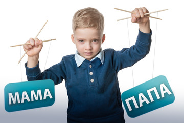 child manipulates the parents. the boy is holding puppets with the words mom and dad on a white...