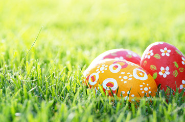 Handmade Painted Easter eggs on green spring grass. Space for text