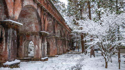 Photo of the beautiful winter landscape at the large brick aqueduct that passes through the temple grounds in Kyoto City's Nanzenji Temple in Japan.