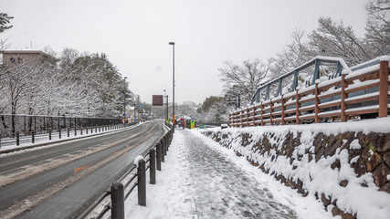 Landscape photo of the ground-covered snow at Keage Incline during a rare heavy snowfall in Kyoto City during a cold winter.