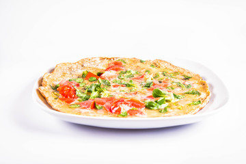 Omelette with tomatoes and fresh corn salad on a white background
