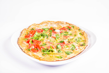 Omelette with tomatoes and fresh corn salad on a white background