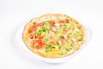 Omelette with tomatoes and fresh corn salad on a white background