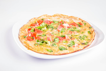 Omelette with tomatoes and fresh corn salad on a white background