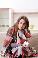 Naklejka premium Sick young woman suffering at home 