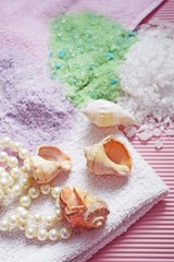 Fototapeta na wymiar Colorful bath salt on pink background.Healthy skin care.