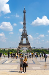 Fototapeta na wymiar Young couple admiring view of Eiffel tower, Paris, France