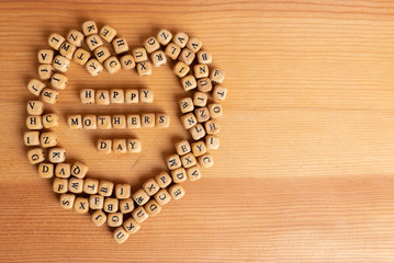 Mothers day concept - wooden word blocks form Happy mothers day.
