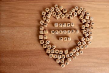Mothers day concept - wooden word blocks form Happy mothers day.