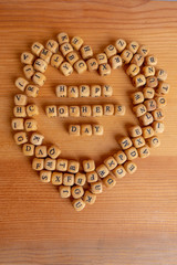 Mothers day concept - wooden word blocks form Happy mothers day.