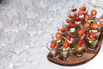 Close-up of empty glasses and glasses with canapes