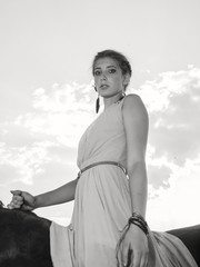 young beautiful serious  girl  riding horse