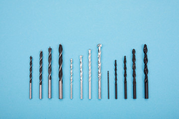 Set of drills are spread out in a row on blue background