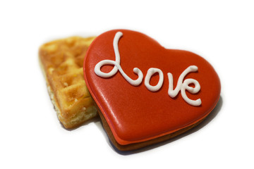 decorated red heart shaped cookies with word LOVE on white background, top view.