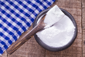 baking soda in bowl on wooden table