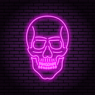 The image of the skull of neon purple lamps with a bright glow on the background of a brick wall.