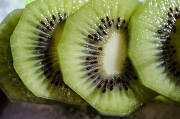 close up photo of sliced kiwi on a plate
