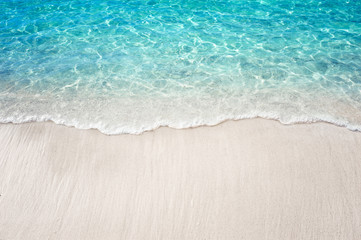 Fototapeta na wymiar Soft blue ocean wave on clean white sandy beach