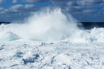 Big waves on the beach. Sea water splash with foamy wave