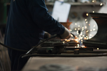 Close-up of blacksmith doing welding repair work