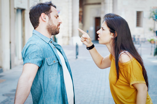 Young couple arguing in the city street