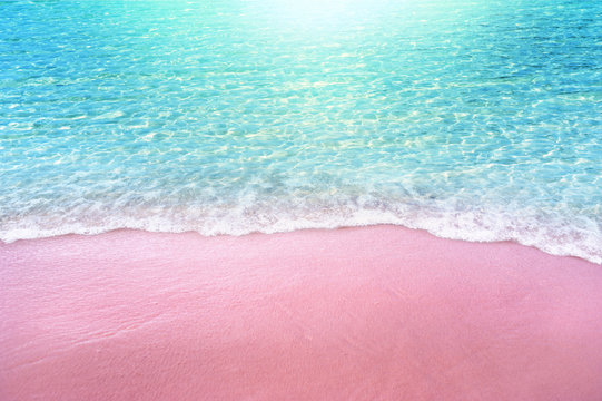 pink sandy beach and soft blue ocean wave summer concept background