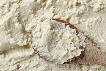 Horseradish sauce with wooden spoon background and texture
