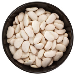 Dried lima beans in a ceramic bowl. View from above. Isolated on white background.