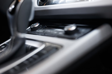 Car interior. Modern car illuminated dashboard. Luxurious car instrument cluster. Close up shot of automobile instrument panel. Modern car interior dashboard and steering wheel