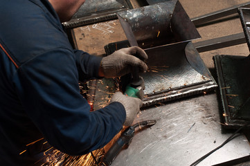 Close up of blacksmith hands and a metal plate