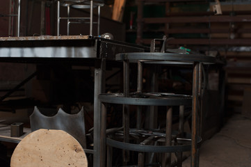 Row of metal chairs in blacksmith workshop
