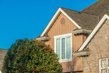 The top of the house or apartment building with nice window.