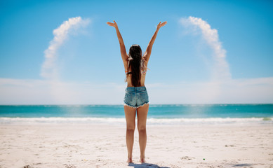 Woman playing with sand at the beach