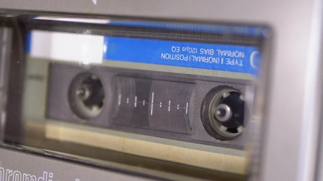 Audio Cassette is inserted into the Deck of the Audio Tape Recorder Playing and Rotates