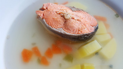 Seafood soup. Soup with salmon in a white plate.