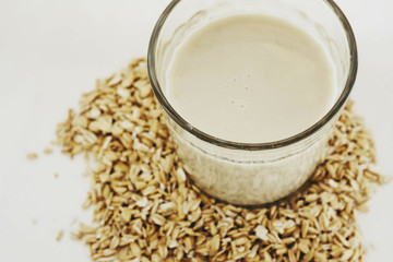 Plant milk. Oat grains milk on white background. Healthy food