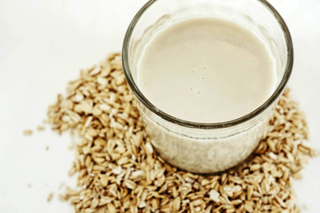 Plant milk. Oat grains milk on white background. Healthy food