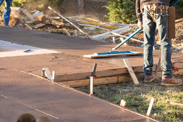 Construction Worker Smoothing Wet Cement With Trowel Tool