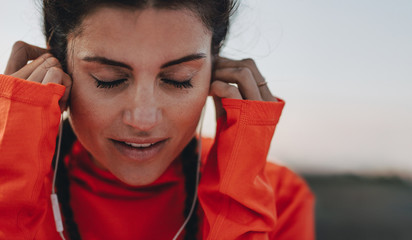 Female runner listening to music