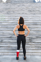 Confident young sports woman resting after exercising