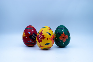 Colorful wooden easter eggs and chocolate with a touch of spring