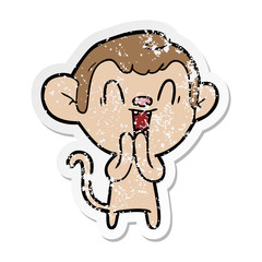 distressed sticker of a cartoon laughing monkey